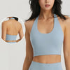 Light blue halter neck sports bra top worn by a woman, showing the front and back view.