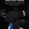 Black men's outdoor cycling gloves being worn on a bicycle handlebar.