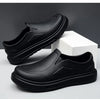 A black men's anti-slip oil-resistant kitchen clog shown from the side against a white background.