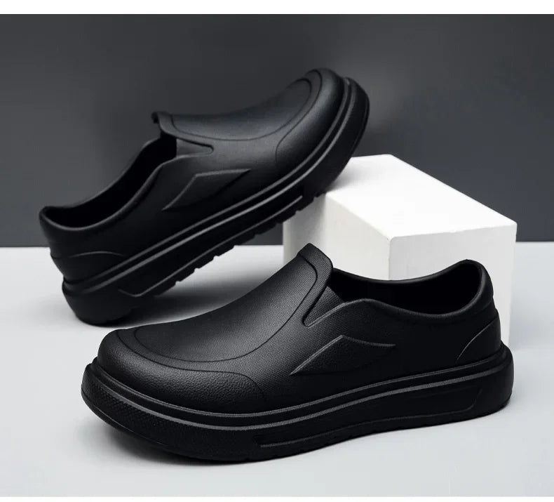 A black men's anti-slip oil-resistant kitchen clog shown from the side against a white background.