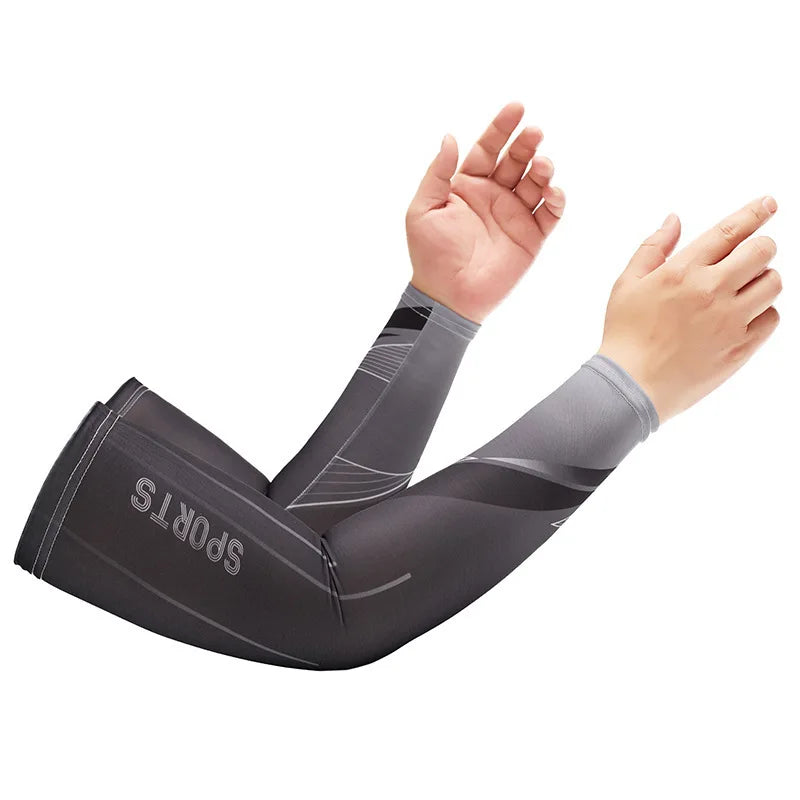 A person wearing dark gray dynamic breathable arm sleeves for sports is shown raising their arms.