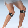 A person wearing a black knee strap for pain relief and stabilization on their lower leg.