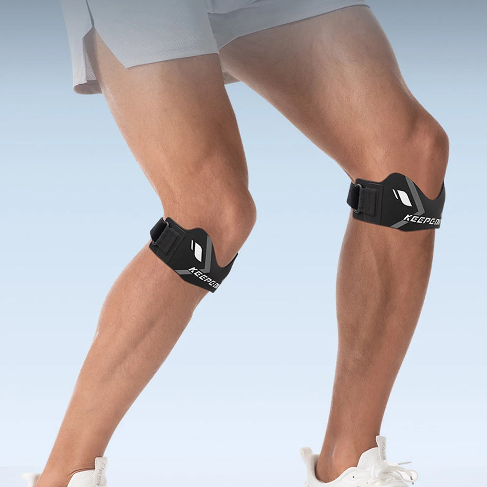 A person wearing a black knee strap for pain relief and stabilization on their lower leg.