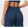 A close-up shot of a woman wearing navy blue high-waist flared yoga pants.