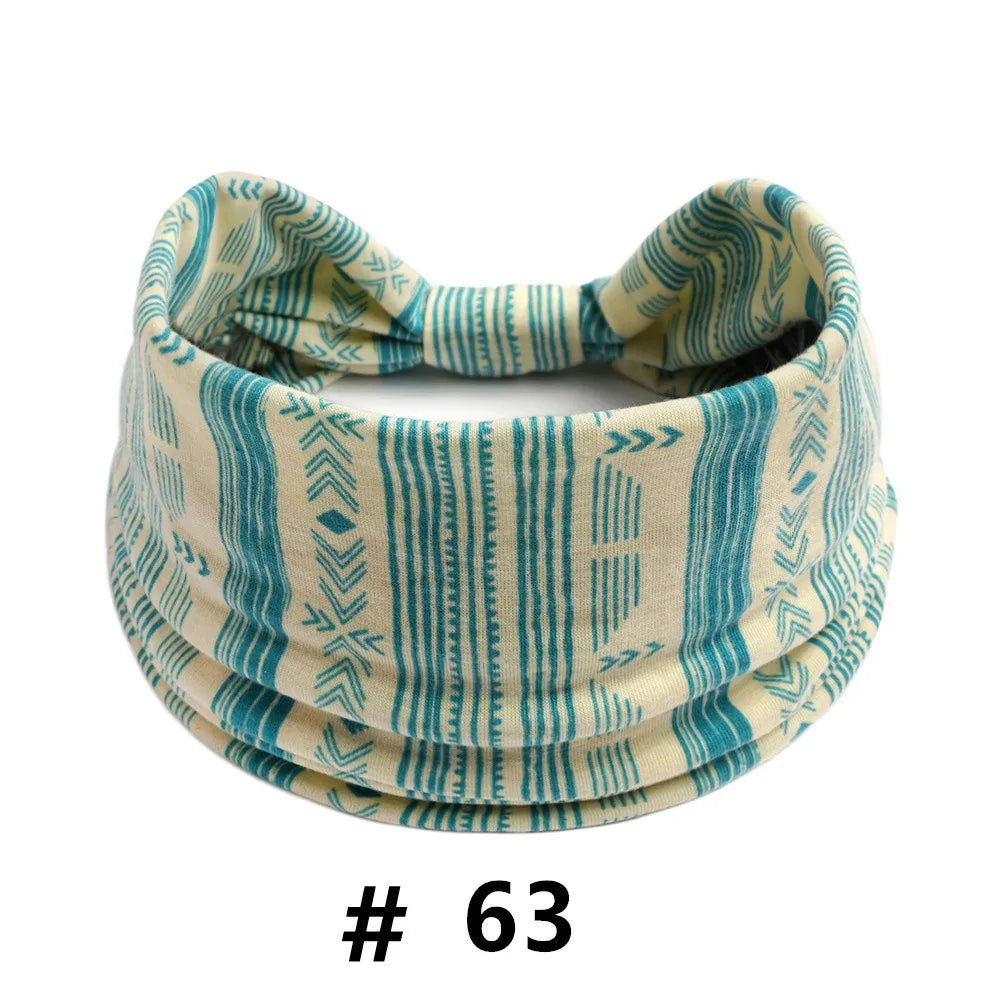 A beige and teal striped cotton turban headband for workout or yoga.
