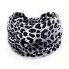A black and white leopard print fabric headband wrapped around a person's head.