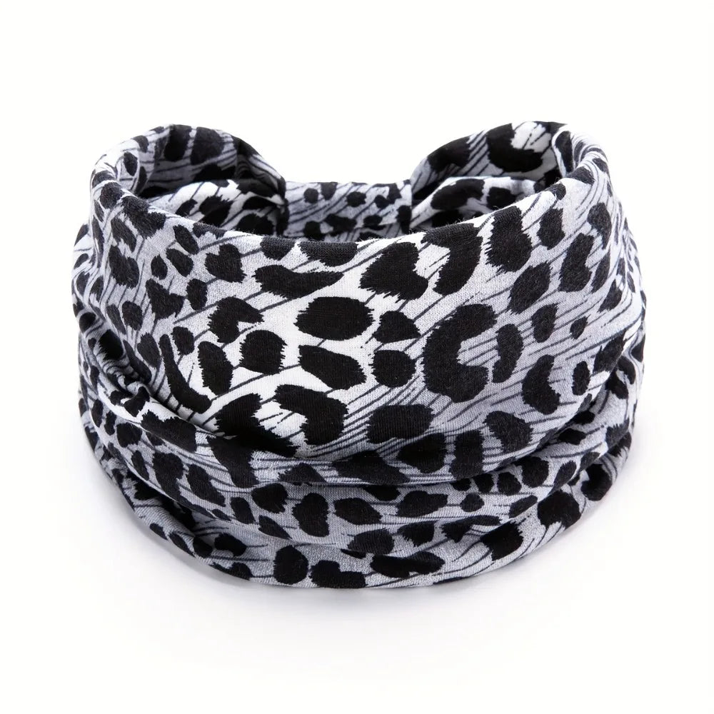 A black and white leopard print fabric headband wrapped around a person's head.