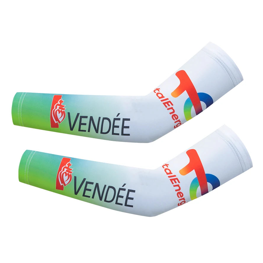 A pair of white cycling arm warmers with green accents and red logos for muscle support.