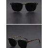 A pair of olive green sunglasses with tortoiseshell accents shown in two views.