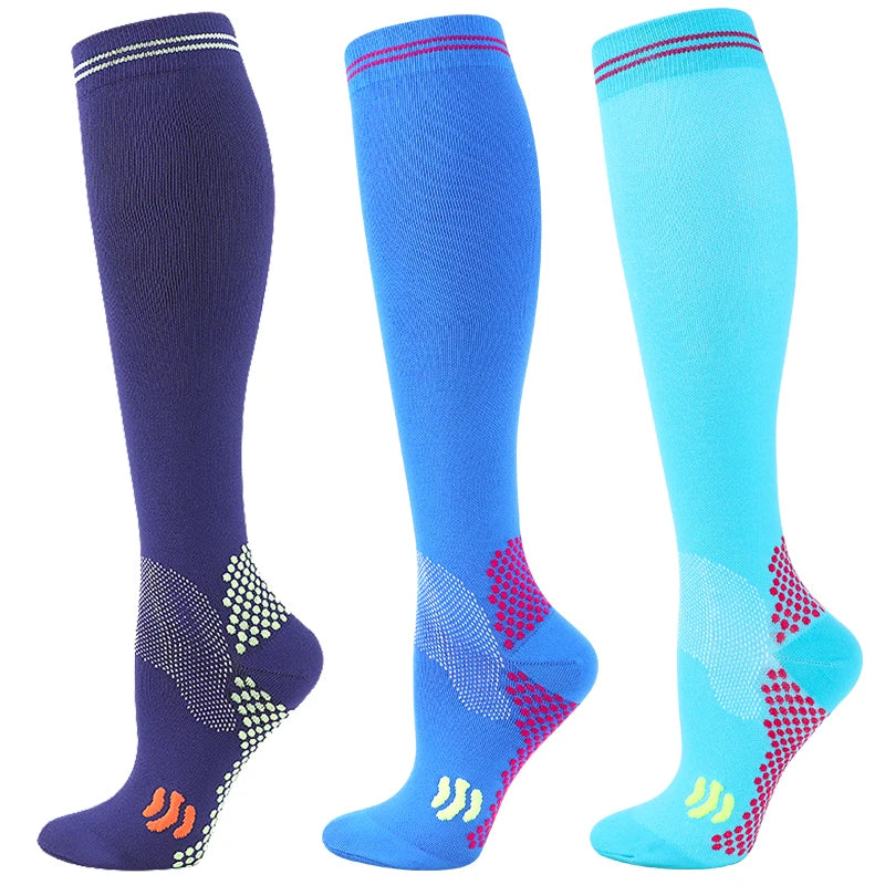 Three pairs of medical grade compression socks in navy blue, royal blue, and cyan