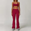 A woman models a maroon three-piece yoga sports set consisting of a cropped top and full-length leggings.