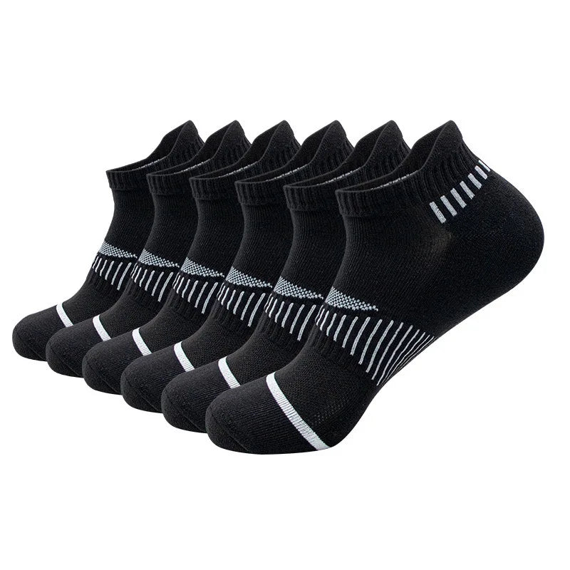 A row of black crew socks for men with white stripes and dots.