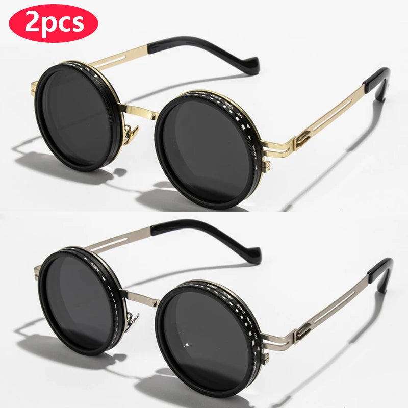 A pair of black round sunglasses with gold-toned metal frames and adjustable dimming.