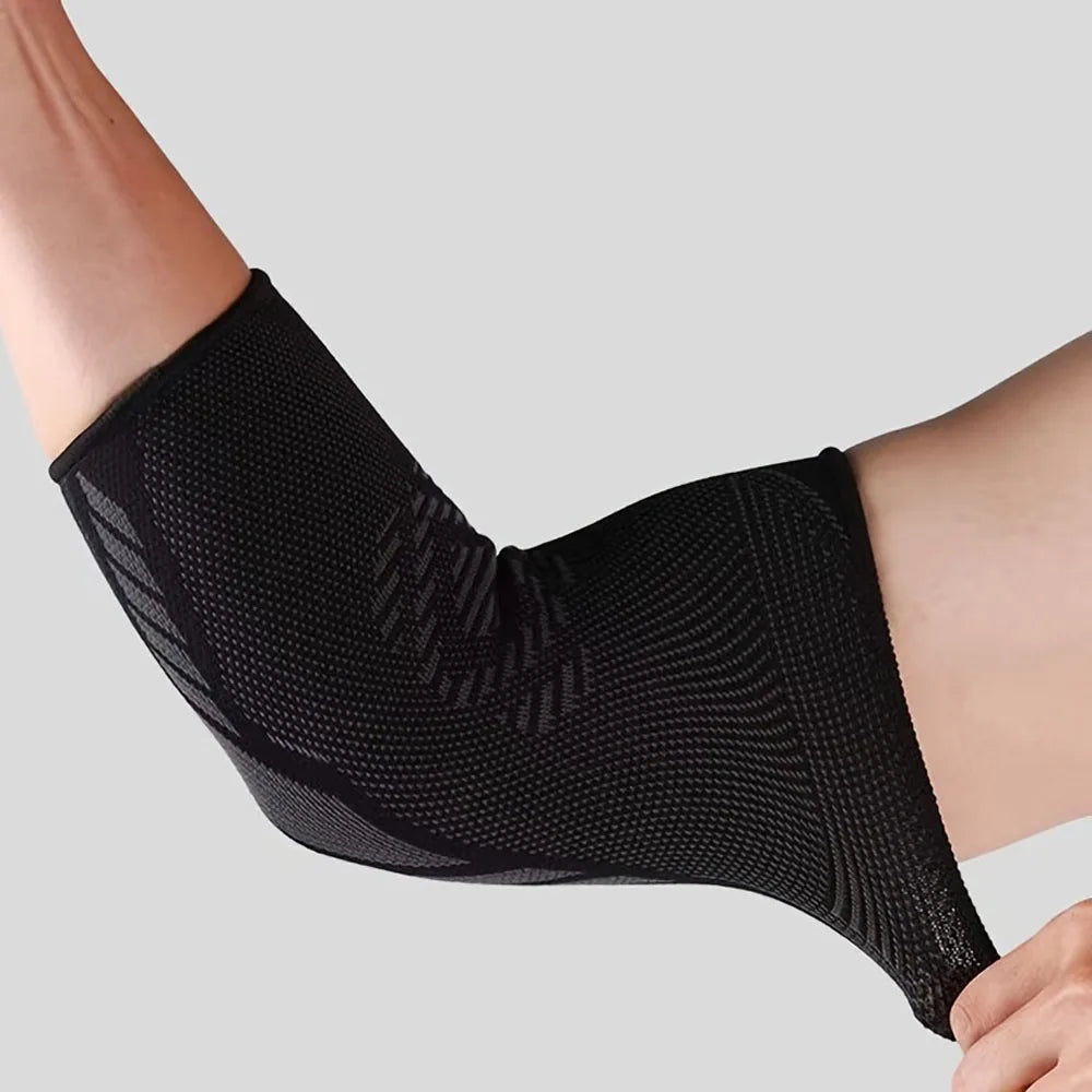 Black breathable stretchy elbow support sleeves worn on a person's arm.