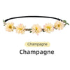 A floral rose wreath crown headpiece with yellow and cream flowers on a black band.