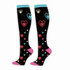 A pair of black compression elastic socks decorated with colorful heart patterns.