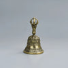 Cloche de bronze à tenir avec sommet orné et base évasée, utilisée pour la décoration spirituelle ou festive.