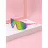 Pink sports sunglasses with a gradient lens resting on a white surface.