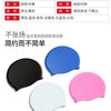 A set of waterproof silicone swimming caps in black, blue, pink, and white colors.