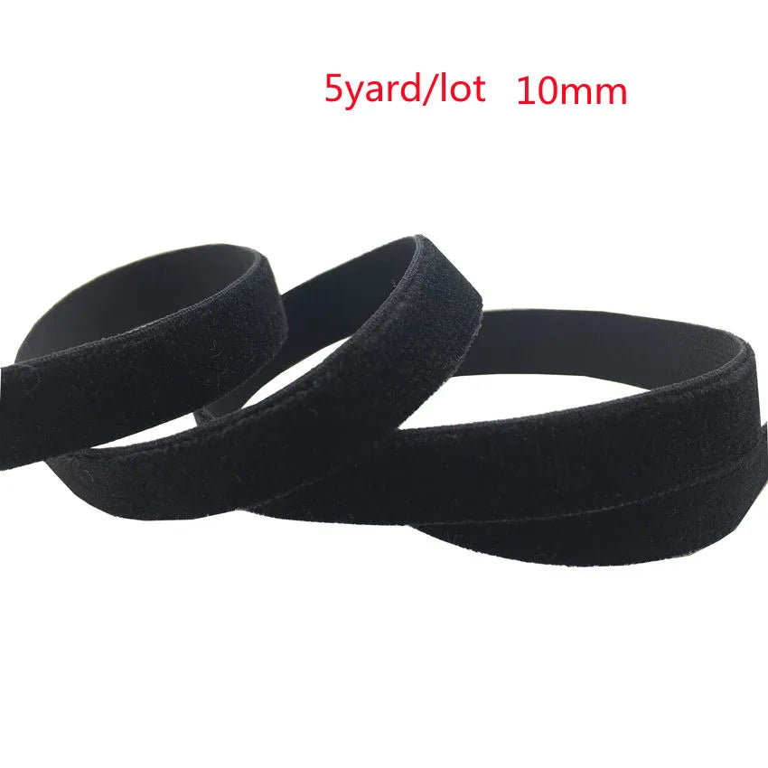 Black stretch velvet elastic headbands shown in a coiled or looped arrangement.