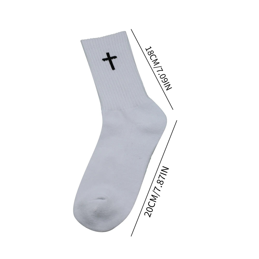 A white knit sports sock with a black cross detail shown from the side.
