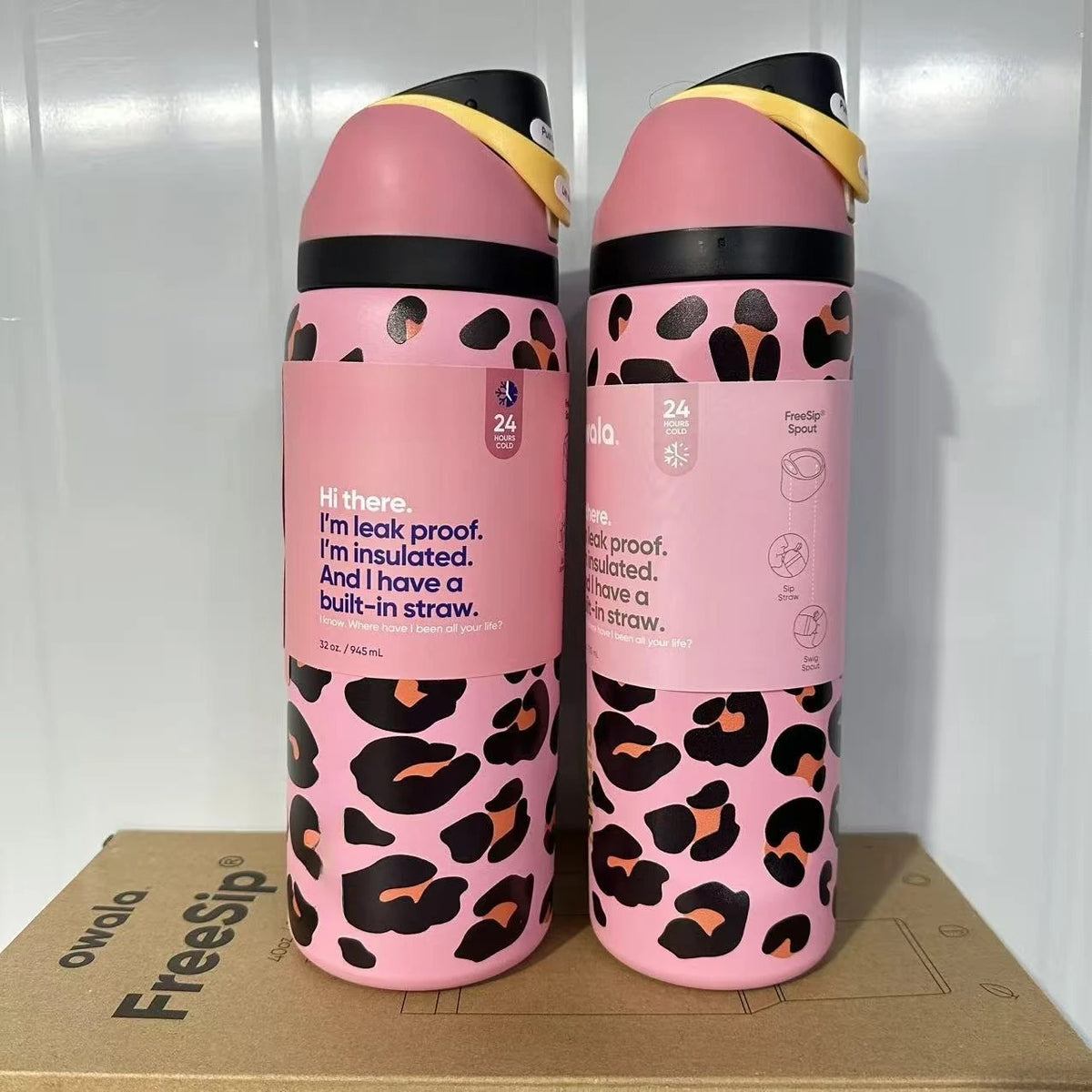 A pink insulated water bottle with a black leopard print design and a yellow lid, standing upright.
