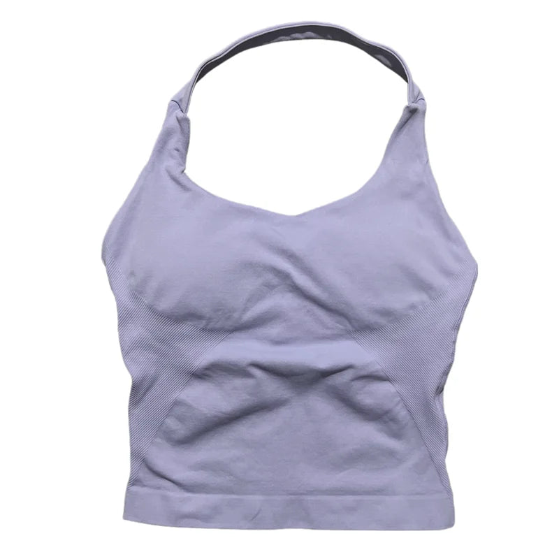 A light purple seamless performance yoga and gym tank top worn by a person.