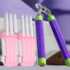 A pair of pink fidget toys with white fingers and green accents are shown against a purple background.