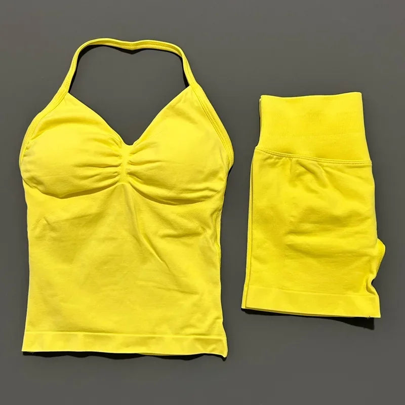 A bright yellow women's seamless backless fitness set consisting of a cropped top and matching long-sleeved bottoms.