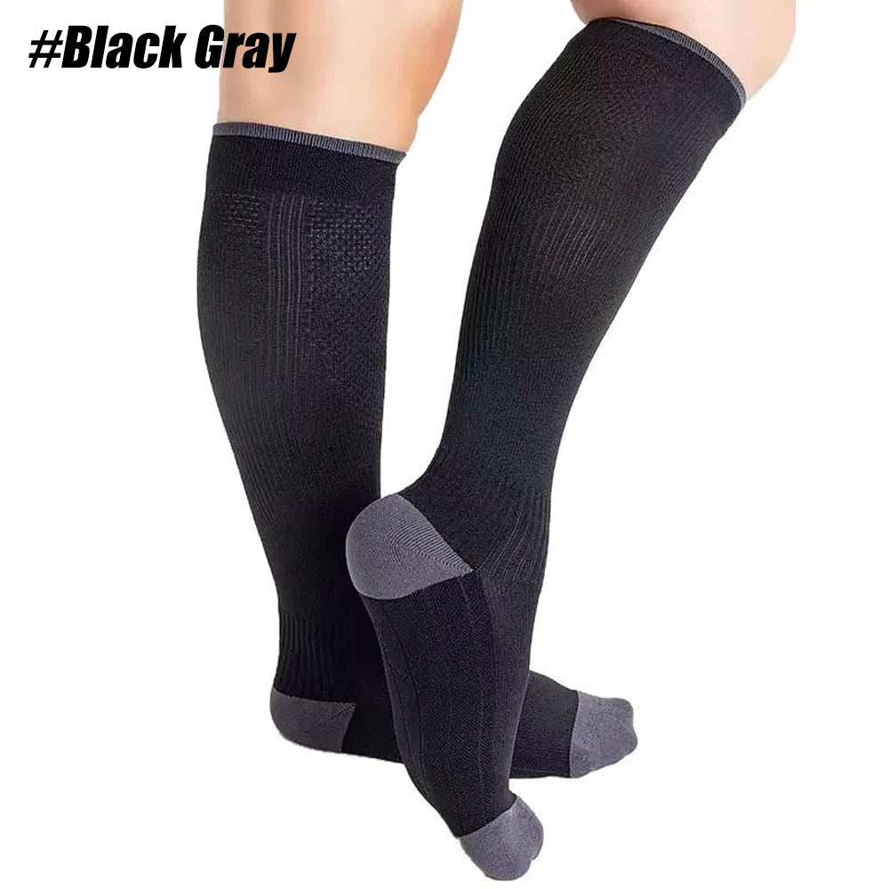Black compression socks worn on a person's leg.