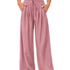 A model is wearing dusty rose flowy high waist drawstring wide leg pants with a white cropped top.