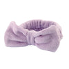 A soft lavender microfiber spa headband and wristband set.