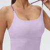 A purple women's athletic crisscross tank top worn by a model.