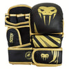 A pair of black boxing gloves with gold trim and a stylized skull design for MMA and Muay Thai training.