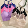 A collection of ribbed crop tops and sports bras in various shades of pink, purple, blue, and black laid out on a light surfa