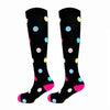 A pair of black compression elastic socks with colorful polka dots.