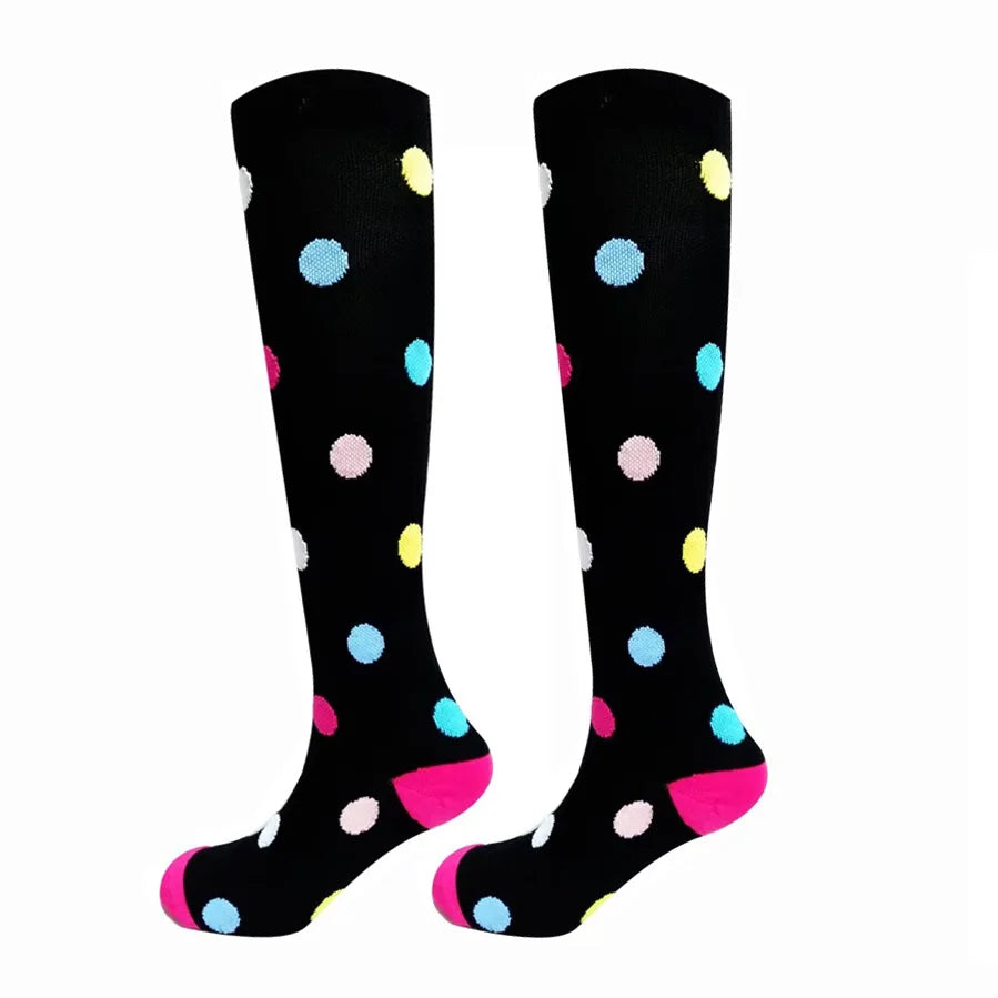 A pair of black compression elastic socks with colorful polka dots.