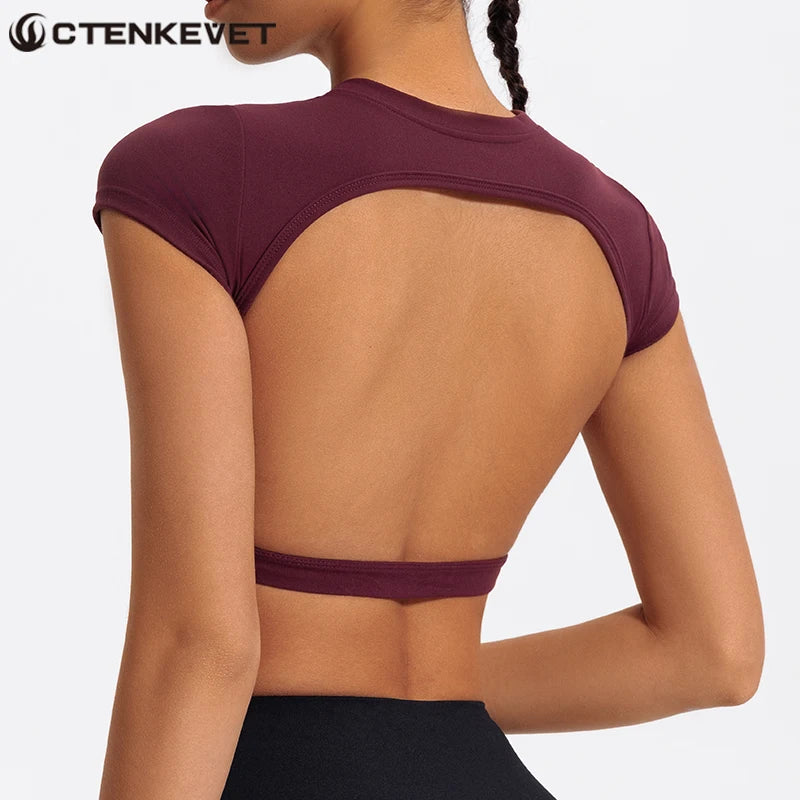 A woman wearing a maroon women's fitness crop top yoga and gym t-shirt from the back view.