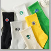 A collection of men's athletic crew socks in various colors including black, white, yellow, and green with embroidered logos.