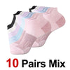 A stack of ten pairs of mixed-color performance compression ankle socks in various shades of pink and purple.