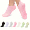 A set of grip pilates socks in various shades of pink and green for yoga and barre