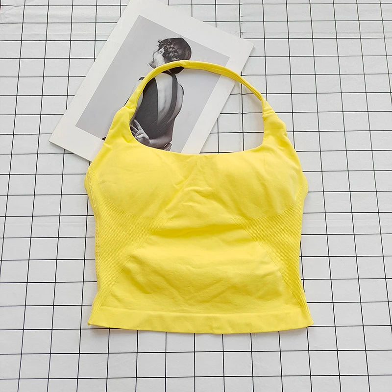 A bright yellow seamless sports camisole top laid on a grid background next to a photo.