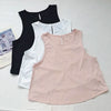 Ein Set aus drei nahtlosen Sport-Tanktops in Schwarz, Weiß und Pink für Yoga und Fitness.