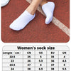 A collection of women's and men's socks displayed next to a running track, showing various sizes.
