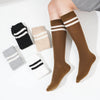 A pair of brown striped cotton knee high socks with white stripes and black accents displayed on a white background.