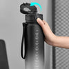 A hand is shown opening the cap of a black sports water bottle with volume markings on the side.