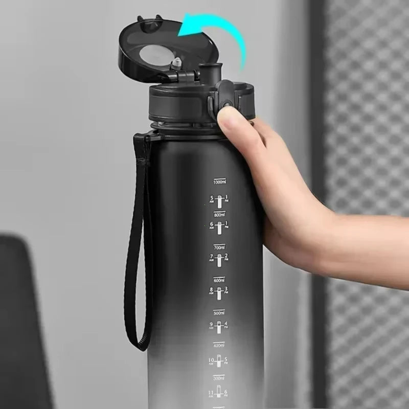 A hand is shown opening the cap of a black sports water bottle with volume markings on the side.