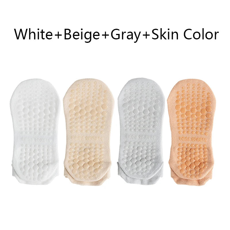 A pack of four non-slip yoga socks in white, beige, gray, and skin colors.