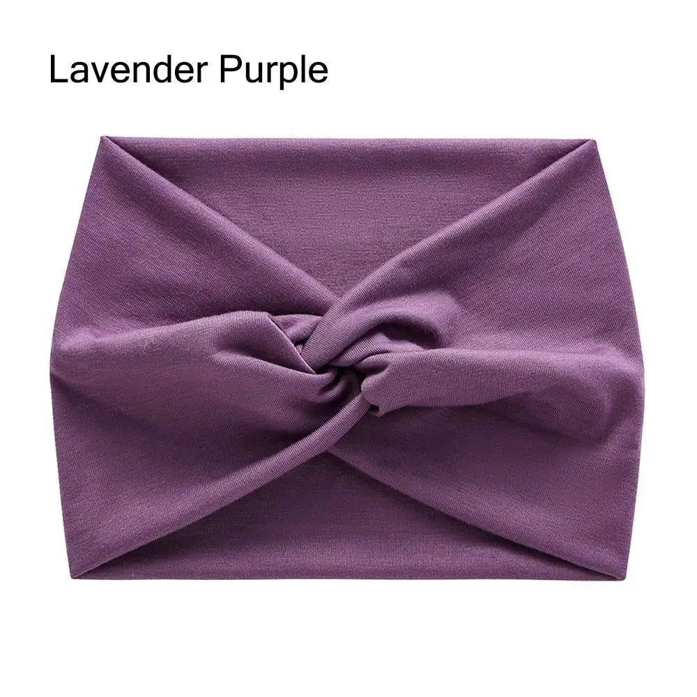 A purple cross-knotted fabric headband for yoga and workout.
