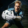 A male soccer goalkeeper wearing dark blue uniform and white gloves is positioned in front of a net.